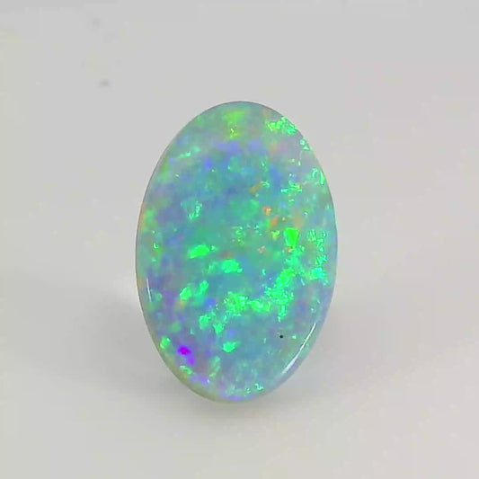 Video of an Oval-shaped opal stone with multicolour fluorescence on a white background