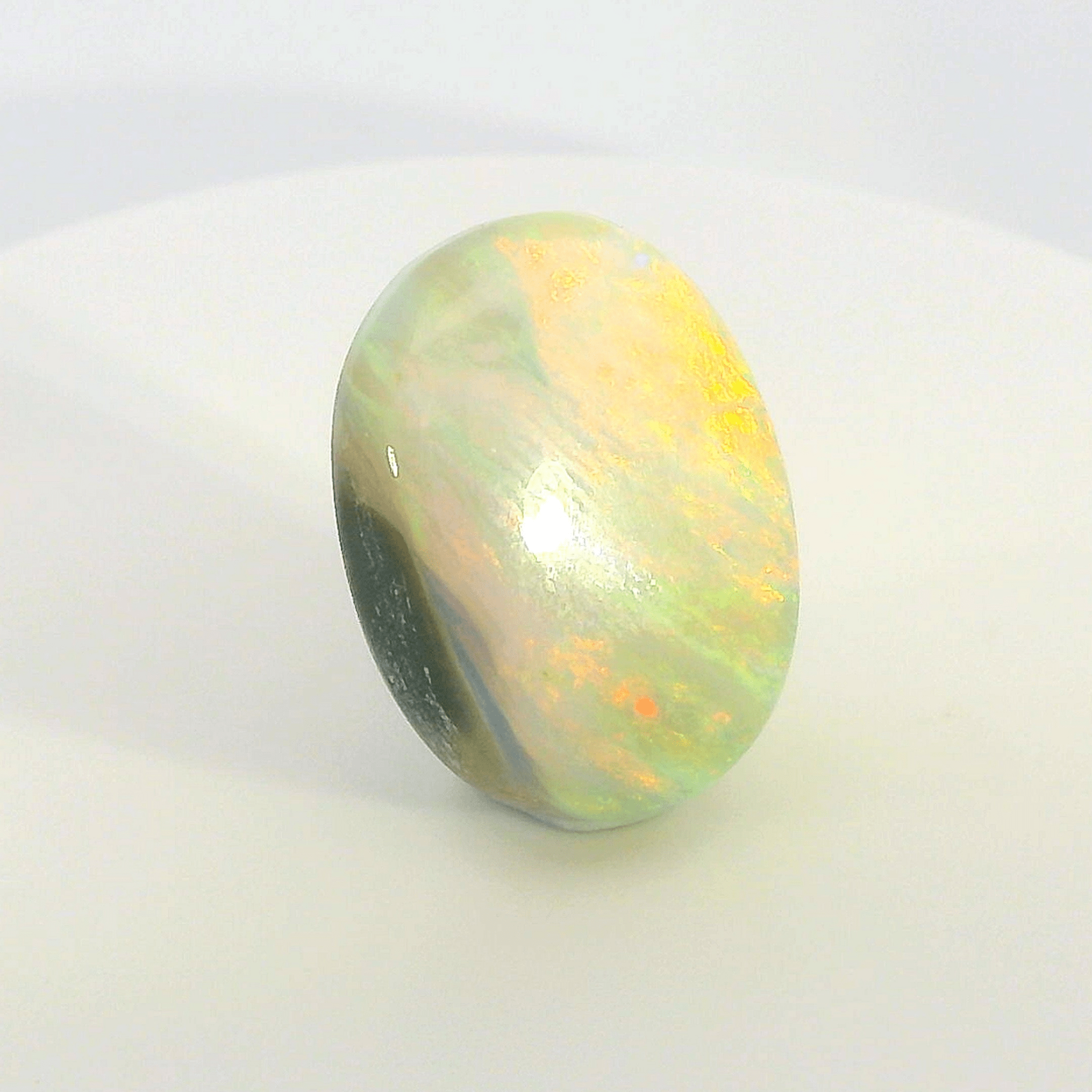 Vibrant Opal Gemstone in Hand - Australian Opal Cutters and Pearl Divers