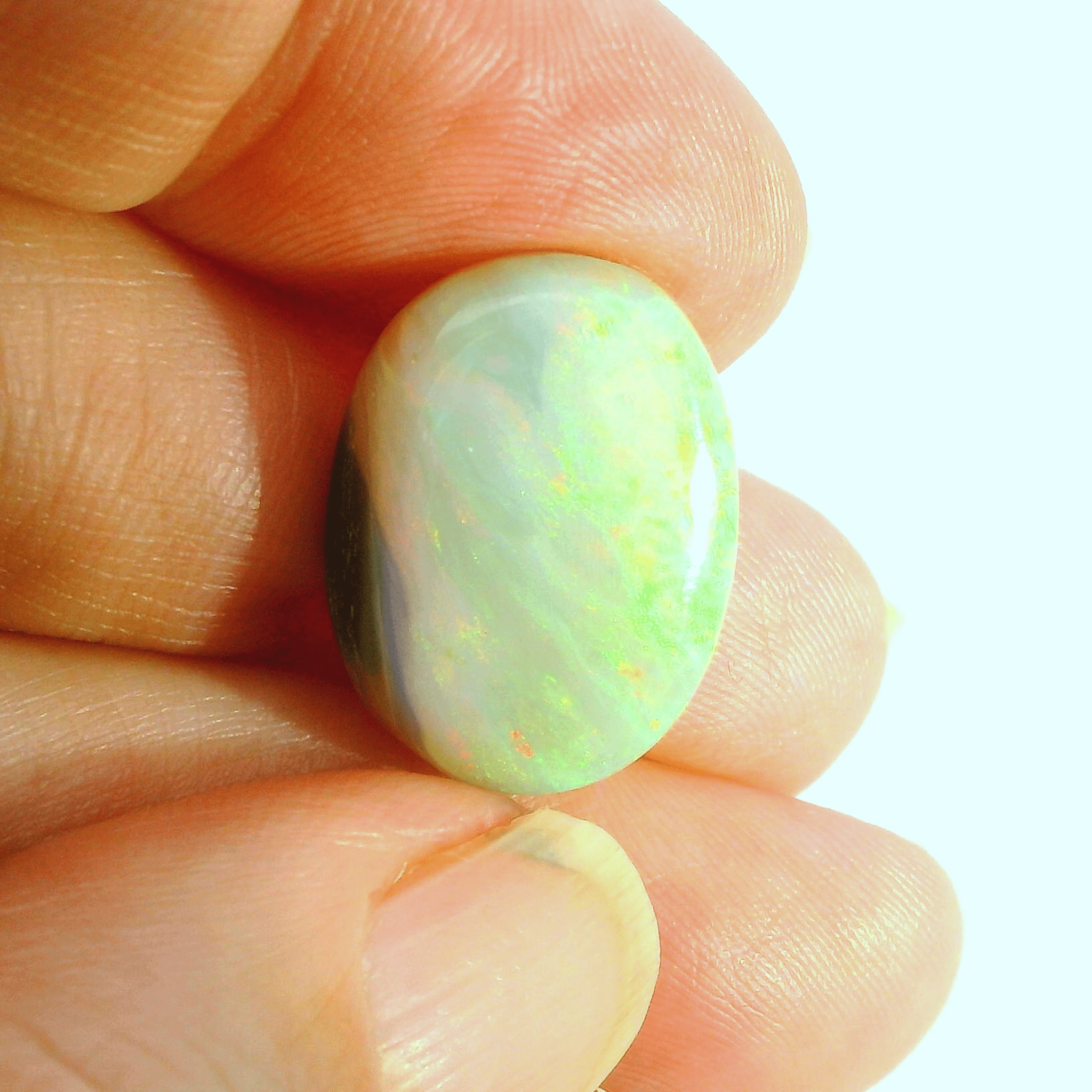 Vibrant Opal Gemstone in Hand - Australian Opal Cutters and Pearl Divers