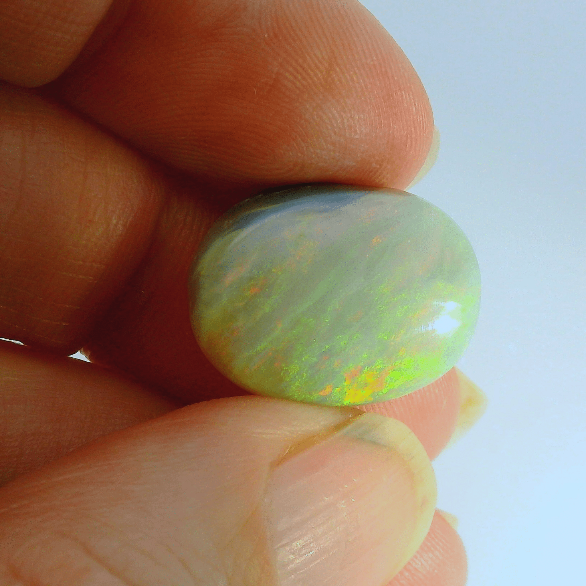 Vibrant Opal Gemstone in Hand - Australian Opal Cutters and Pearl Divers